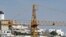 A crane is seen over an abandoned tourist resort construction in Gale on the southern Portuguese province of Algarve, March 6, 2012.