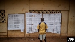 A Gabonese voter checks the registry at a polling station in the Rio district during the presidential election on Aug. 27, 2016, in Libreville.