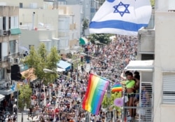 FILE - Revellers take part in an annual gay pride parade in Tel Aviv, Israel. June 14, 2019.