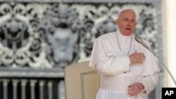 FILE - Pope Francis makes the sign of the cross during his weekly general audience, in St. Peter's Square, at the Vatican, May 8, 2019. 