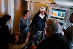 President Donald Trump talks with reporters aboard Air Force One, en route to Washington, Sept. 14, 2017.