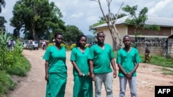 FILE - From left, journalists Christine Kamikazi, Agnes Ndirubusa, Terence Mpozenzi and Egide Harerimana leave High Court in Bubanza, Burundi, Dec. 30, 2019, after attending a trial session. The four, sentenced on a security charge, have been pardoned.
