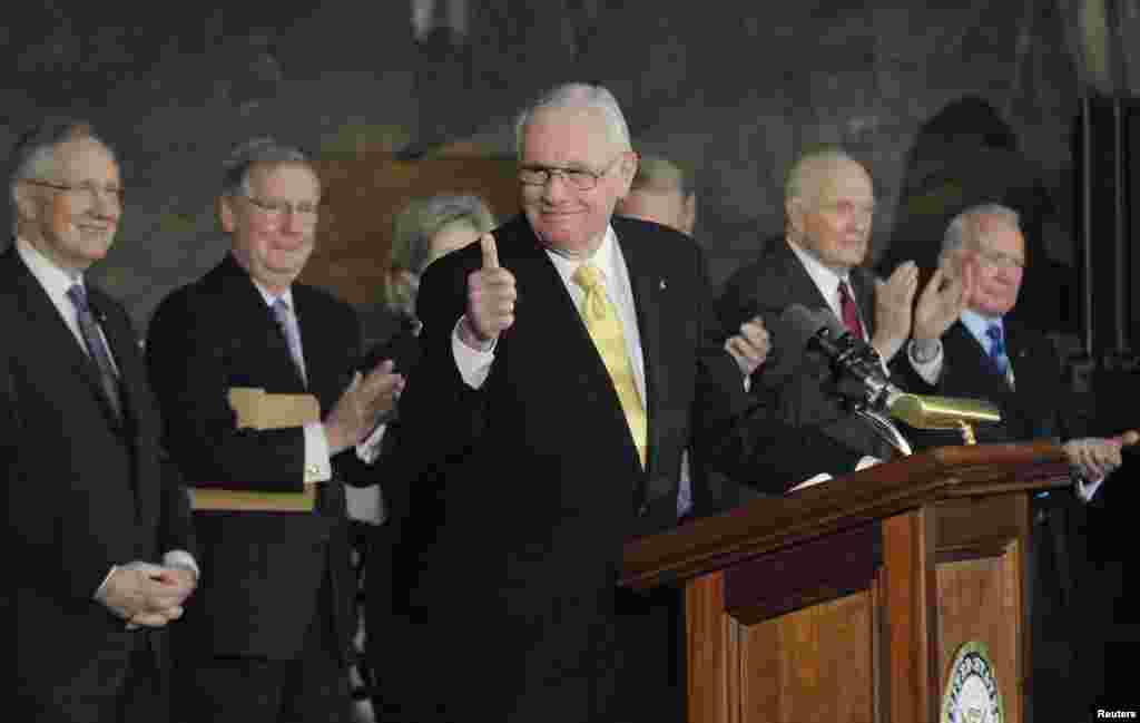 U.S. astronaut Neil Armstrong (C) gives a thumbs-up after receiving the Congressional Gold Medal at the U.S. Capitol in Washington, November 16, 2011.