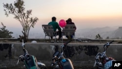 A couple watches the sunset atop Mount Qassioun, which was opened to the public after the fall of the Assad regime, in Damascus, Syria, Jan. 2, 2025.