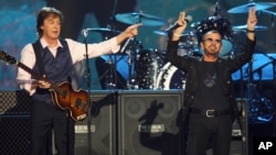 Paul McCartney, left, and Ringo Starr perform at "The Night that Changed America: A Grammy Salute to the Beatles," in Los Angeles, Jan. 27, 2014.