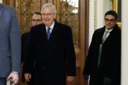 Senate Majority Leader Mitch McConnell, R-Ky., walks past the entrance to the Senate chamber as the arrives at his office at the Capitol, Jan. 22, 2020.