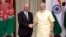 FILE - Indian Prime Minister Narendra Modi, right, shakes hands with Afghan President Ashraf Ghani in New Delhi, India, Sept. 14, 2016.