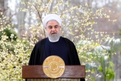 In this photo released by the official website of the office of the Iranian Presidency, President Hassan Rouhani delivers a message in Tehran, Iran, March 20, 2020.