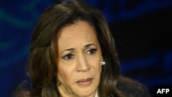 US Vice President and Democratic presidential candidate Kamala Harris listens to former US President and Republican presidential candidate Donald Trump speak during a presidential debate at the National Constitution Center in Philadelphia, Pennsylvania, o