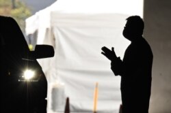 A health care worker in Redondo Beach, California, works at a new coronavirus drive-thru  testing site on April 3, 2020.