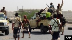 FILE - Yemeni pro-government forces gather on the eastern outskirts of Hodeida as they continue their battle to wrestle control of the city from Houthi rebels, Nov. 10, 2018.