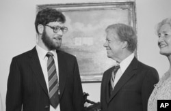 FILE - President Jimmy Carter appears with freed hostage Richard Queen at the White House, July 19, 1980. Queen was released from captivity in Iran due to health reasons.