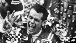 FILE - In this May 24, 1981, photo, Bobby Unser holds three fingers aloft after winning his third Indianapolis 500 auto race ,in Indianapolis, Ind.