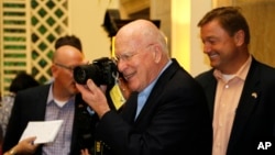 Sen. Patrick Leahy, D-Vt. turns his camera on reporters after a news conference in Havana, Cuba, June 27, 2015.