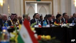 FILE - Delegates attend the second Kabul Process conference at the Presidential Palace in Kabul, Afghanistan, Feb. 28, 2018. Afghanistan President Ashraf Ghani is calling on the Taliban to take part in peace talks to "save the country." 