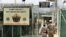 US military guards walk within Camp Delta military-run prison, at the Guantanamo Bay US Naval Base, Cuba, June 27, 2006.