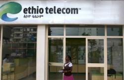 A woman walks past an Ethio Telecom office in Ethiopia's capital, Addis Ababa, Nov. 9, 2015.