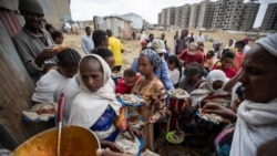 Displaced Tigrayans queue to receive food donated by local residents at a reception center for the internally displaced in Mekele, in the Tigray region of northern Ethiopia, May 9, 2021.