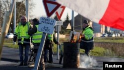 Protesters wearing yellow vests occupy a roundabout in Somain, France, Dec.13, 2018.