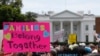 FILE - In this June 20, 2018, file photo, activists march past the White House to protest the Trump administration's approach to illegal border crossings and separation of children from immigrant parents in Washington.