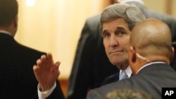 U.S. Secretary of State John Kerry, set to participate in talks on Syria, waves as he arrives at a hotel in Vienna, Nov. 13, 2015.