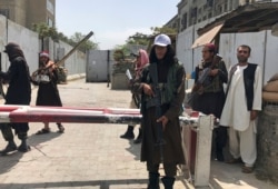 Taliban fighters stand guard at a checkpoint near the U.S. Embassy that was previously manned by American troops, in Kabul, Afghanistan, Aug. 17, 2021.