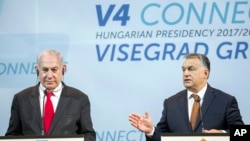 Israeli Prime Minister Benjamin Netanyahu, left, listens to Hungarian Prime Minister Viktor Orban during a press conference held after the talks of Netanyahu with heads of government of the Visegrad Group in the Pesti Vigado building in Budapest, Hungary, July 19, 2017.