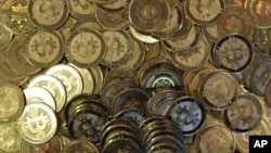 FILE - Bitcoin tokens at 35-year-old software engineer Mike Caldwell's shop in Sandy, Utah, April 3, 2013. 