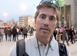 FILE - This undated file still image from video released April 7, 2011, by GlobalPost, shows James Foley of Rochester, N.H., a freelance contributor for GlobalPost, in Benghazi, Libya.