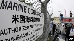 People form a 'human chain' around U.S. Futenma airbase on the Japanese island of Okinawa during an earlier protest against US troops there on May 16, 2010.