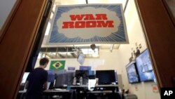 A man works at his desk in the war room, where Facebook monitors election related content on the platform, in Menlo Park, Calif., Wednesday, Oct. 17, 2018.