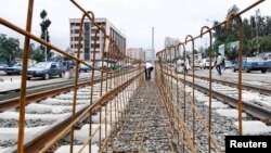FILE - A laborer works at a light railway transit system under construction in Ethiopia's capital, Addis Ababa, June 25, 2014. Profitability concerns have slowed funding from China for some rail projects.