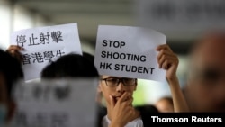 A protester holds a sign following a day of violence over an extradition bill that would allow people to be sent to mainland China for trial, in Hong Kong, China June 13, 2019. 