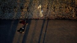 FILE - A bicycle rack on the campus of Harvard University in Cambridge, Massachusetts, sits mostly empty as the school remains closed with classes moved online, March 26, 2020.