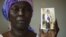 FILE - Martha Mark, mother of kidnapped schoolgirl Monica Mark, cries as she displays her photo in the family's house in Chibok, Nigeria, May 19, 2014