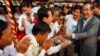 Cambodian Prime Minister Hun Sen, right, greets villagers as he arrives for an inauguration ceremony of a road funded by Japan for its official use at Kdey Takoy village, outside of Phnom Penh, Cambodia, Tuesday, March 13, 2018. (AP Photo/Heng Sinith)