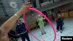FILE - Patients with Alzheimer's and dementia are seen during a therapy session inside the Alzheimer Foundation in Mexico City.