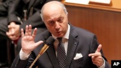 FILE - French Foreign Minister Laurent Fabius addresses members of parliament during questions to the government at the National Assembly in Paris, Oct. 9, 2013.