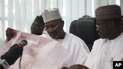 Attahiru Jega, Independent National Electoral Commission Chairman, reads the results sheet before he declared Nigeria's incumbent President Goodluck Jonathan as the winner of the presidential election, in Abuja, Nigeria, April 18, 2011