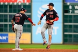 Washington Nationals' Juan Soto and Asdrubal Cabrera celebrate after Game 2 of the baseball World Series against the Houston Astros, Oct. 24, 2019, in Houston.