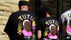 FILE - Ambassadors of the Tygerberg Hospital Children's Trust stand in matching T-shirts on the eve of celebrating Anglican Archbishop Emeritus Desmond Tutu's 90th birthday in Cape Town, South Africa, Oct. 6, 2021.