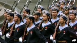 FILE - Vietnamese sailors march in Hanoi, March 1, 2001, ahead of a visit by Russian President Vladimir Putin to discuss, among other topics, Moscow's leasing of Cam Ranh Bay naval base in southern Vietnam.