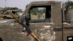 FILE - A rocket propelled launcher hangs on the mirror of a pickup truck in the Nigerian city of Damasak March 18, 2015.