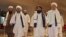 FILE - Taliban officials walk down a hotel lobby during talks in Doha, Qatar, Aug. 12, 2021. UN Secretary-General António Guterres will convene a meeting of various countries’ special representatives for Afghanistan in Qatar on February 18, 2024. 