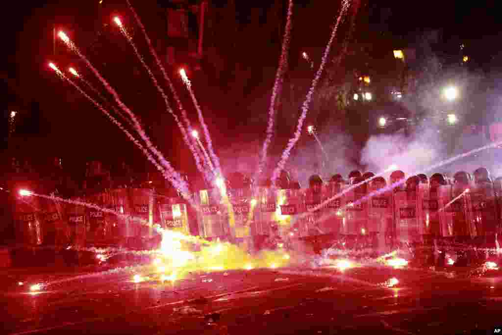Demonstrators use firecrackers against police during a rally against the government's decision to suspend negotiations on joining the European Union for four years, outside the parliament's building in Tbilisi, Georgia.