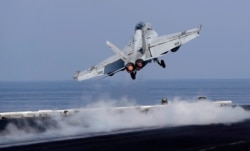 In this picture taken on Nov. 21, 2016, a U.S. Navy fighter jet takes off from the deck of the U.S.S. Dwight D. Eisenhower aircraft carrier.