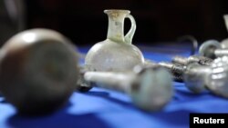 Some of the artifacts from more than 60 Iraqi cultural treasures illegally smuggled into the United States that were returned to the Republic of Iraq, are displayed on a table, the Department of Homeland Security said in Washington, March 16, 2015, as pictured in this undated handout photo provided by the U.S. Immigration and Customs Enforcement (ICE). 