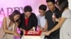Google officials and partners cut into a birthday cake marking YouTube's first year with a Vietnamese version. (Lien Hoang/VOA News)