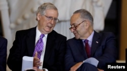Senate Majority Leader Mitch McConnell and Senate Minority Leader Chuck Schumer talk during a ceremony to present the Congressional Gold Medal to Filipino veterans of the Second World War on Capitol Hill in Washington, U.S., October 25, 2017.