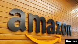 FILE - The logo of Amazon is pictured inside the company's office in Bengaluru, India, Apr. 20, 2018. 